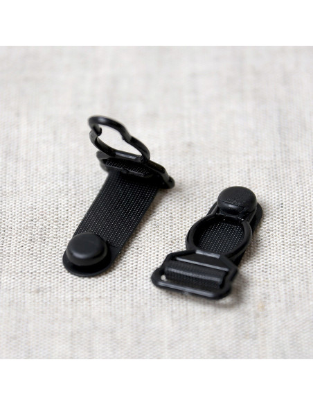 Set de 4 boucles porte jarretelle en plastique - Noir